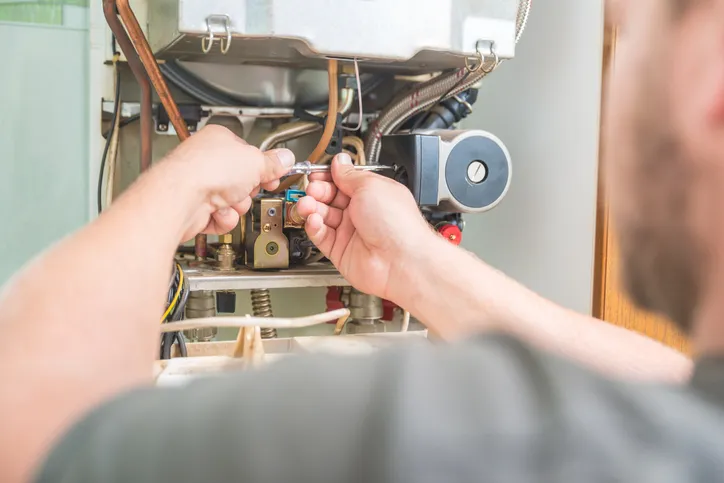 Technician Repairing heater At Home